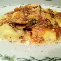 Snapdishの料理写真:Bourbon cheddar beer bolognese over fried potato & brussels w/ ravioli|eli connartonさん