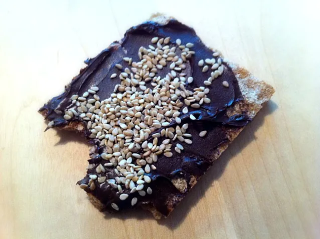 vegan dark chocolate spread on crisp bread, sprinkled wit sesame seeds|Gabiさん