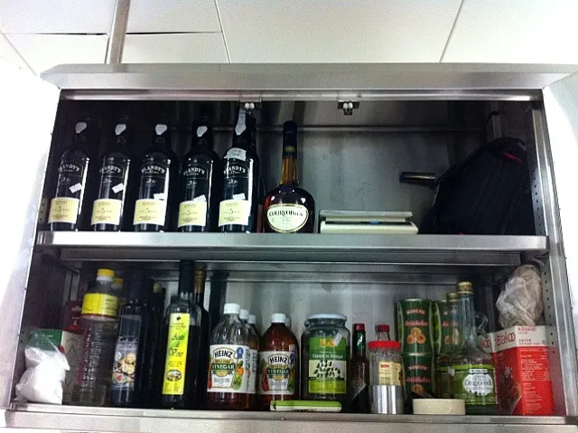 My hotel cabinet of wines, brandy, truffle oils etc|Rhythmiqueさん