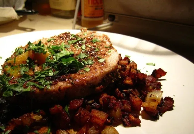 Roasted Porkloin with carmelized onion and sugar tree peaches on a yukon gold hash|dan zahraさん