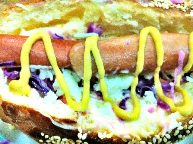 Hotdog sandwich on my freshly made buns on a bed of purple cabbage slaw|caren memanさん