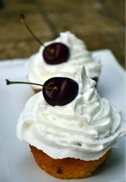 Yellow cupcakes with cherry filling and whipped cream topping|liisさん