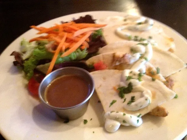 Blackened chicken quesadilla filled with cheddar, pico de gallo and avocado, cilantro sour cream and side salad|valintinus domingoさん