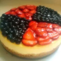 New York style cheesecake topped with blueberries and strawberries