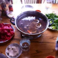 Chinese hot pot - ribeye, greens, squid rings, tofu, mushrooms, carrots, potatoes, and onion in a beef broth|WMWさん