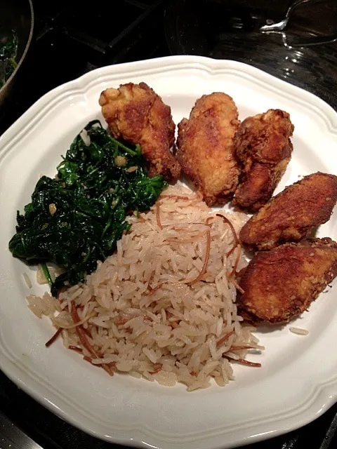 Snapdishの料理写真:Fried chicken wings, rice pilaf and  spinach sautéed in garlic and olive oil|Emmie Pizarroさん