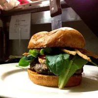 Black truffle stuffed burger with house made Boursin cheese, bourbon molasses glaze, and shaved tobacco fried onion rings on a brioche bun.|valintinus domingoさん