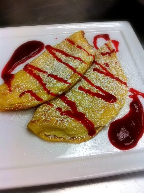 Snapdishの料理写真:Crepes filled with lemon soufflé and drizzled with raspberry sauce|Adriana Munozさん