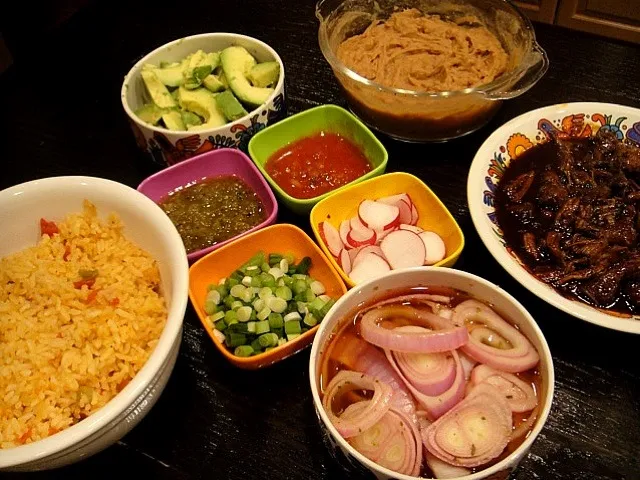 Snapdishの料理写真:Braised lamb tacos with rice & beans. Accompaniments: pickled red onions, radishes, avocado, scallions, tomatillo salsa & red salsa|Holly Doranさん