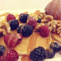 Pancakes with mixed berries, walnuts, chocolate ice cream & butterscotch syrup|Evangelyn.さん