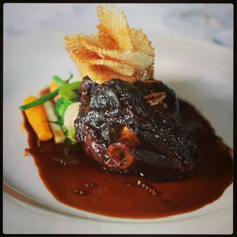 Slow braised lamb shank with fresh farm veggies, port wine jus, pommes Gaufrette|Adrian Buchananさん