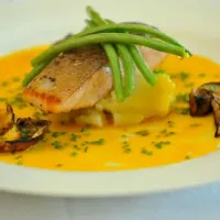 pan fried salmon steak over mashed potato with fine beans, grilled porcini and an emulsification of olive oil & orange.|Adrian Buchananさん