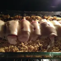 Snapdishの料理写真:Ham and Swiss wrapped chicken over wild rice!! Still cooking so not completely done yet that's why she's still a little pink! Kitchen smells good!!|Jacinda Twymanさん