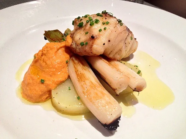 Snapdishの料理写真:Monkfish served on a bed of potatoes and "calçots" (onion variety) and typical romesco sauce.|De Pupesさん