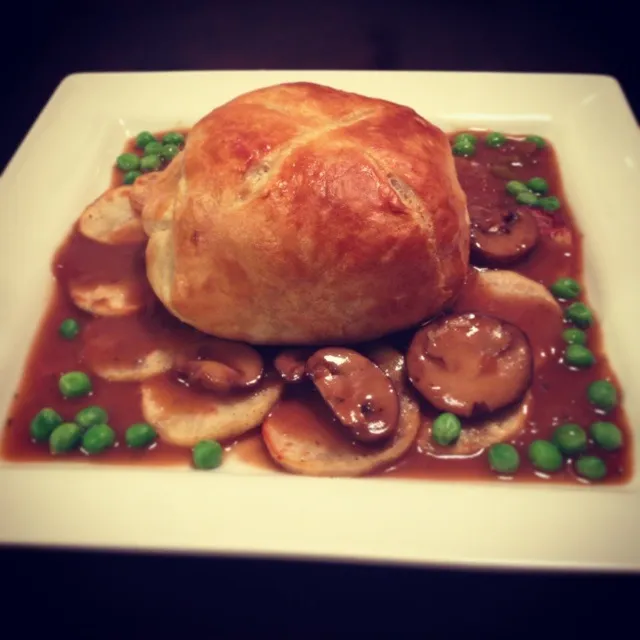 Mini Beef Wellington on sliced roasted garlic potatoes with sweet peas and a Madeira wine sauce with BB portobello mushrooms and diced asparagus.|Brian Churchillさん