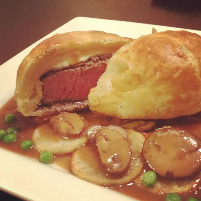 Mini Beef Wellington on sliced roasted garlic potatoes with sweet peas and a Madeira wine sauce with BB portobello mushrooms and diced asparagus.|Brian Churchillさん