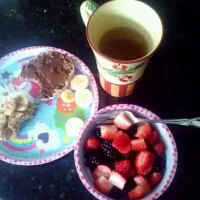 Snapdishの料理写真:Today's breakfast, 1/2 english muffin with pb, banana, cinnamon, and cocoa powder, the other with chocolate hazelnut butter. Fruit salad and green tea with hone|kylie cardenasさん