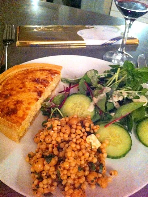 Dinner quiche salad and large cous-cous with some red wine on the side and dessert in the background!|🍓Jolejo🍓さん