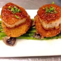 Golden scallops, potato croquets on a bed of sautéed asparagus and mushrooms