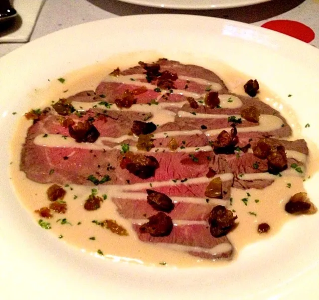 Snapdishの料理写真:Brine cured rare beef with tuna anchovy sauce, deep fried capers and chopped raisins|Mei Meiさん