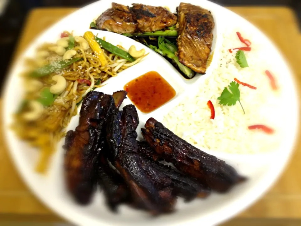 An Asian feast, Chinese spare ribs, soy glazed salmon, vegetable noodles with cashews and Thai rice|Steve Pountneyさん