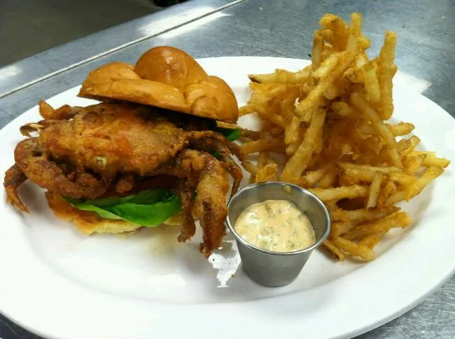 Snapdishの料理写真:Cornmeal battered Soft Shell Crab Sandwich (on Brioche Knot Roll) & Beer Battered French Fries w/ a Cajun Remoulade dipping sauce.|Bryan S. Mooreさん