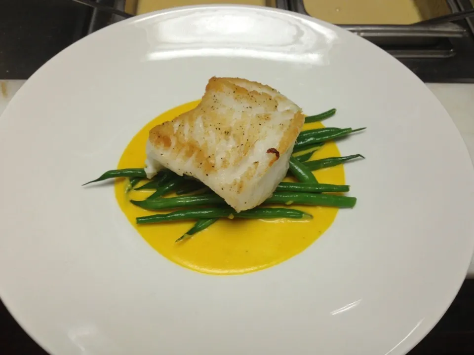 Pan seared sea bass, French beans, roasted yellow tomato nage.|joshua sayersさん