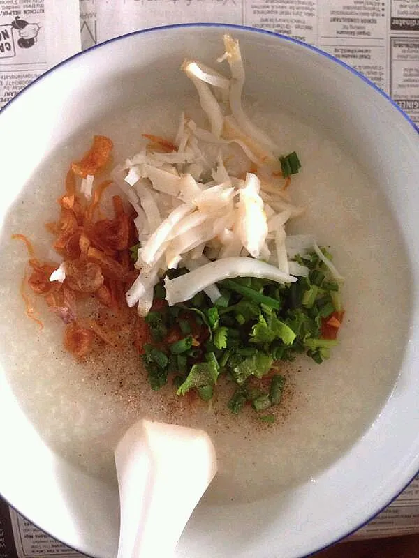 Snapdishの料理写真:Mom's pork rib and scallop congee for brunch.  Mom  also prepares fish cake, spring onions, fried shallots, braised peanuts and  century egg as condiments.|genさん