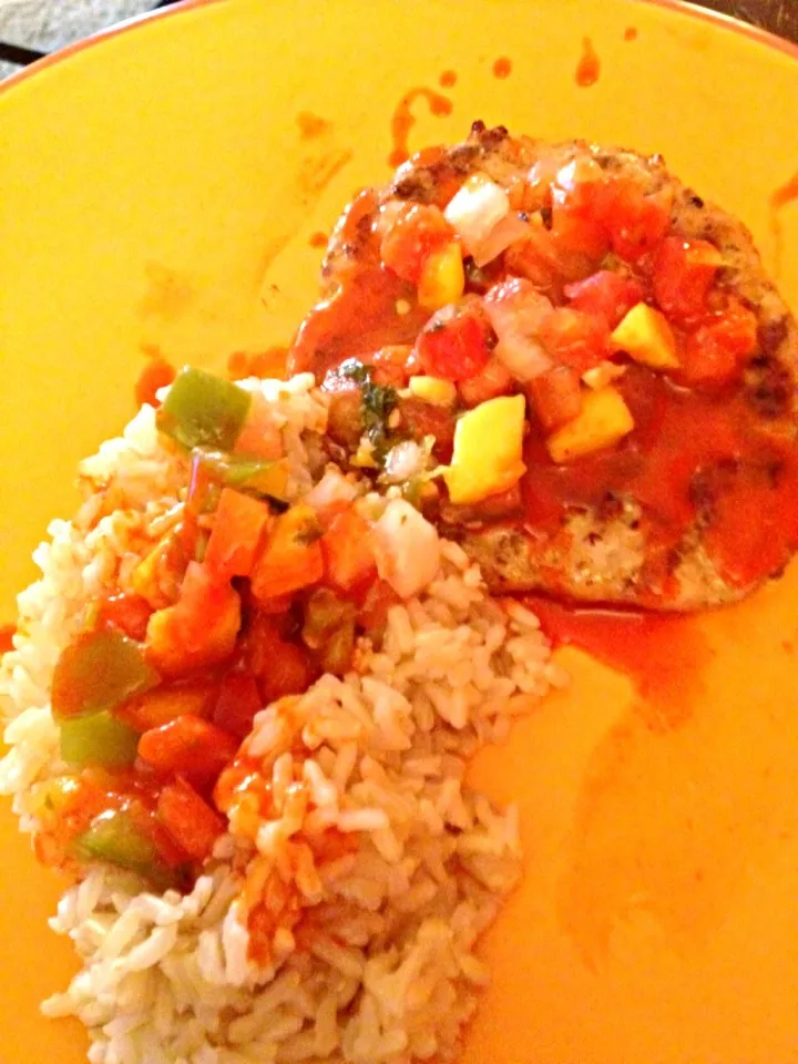 Snapdishの料理写真:Grilled chicken burger with caramelized onions topped with mango salsa and brown rice and chulua sauce.|amyさん