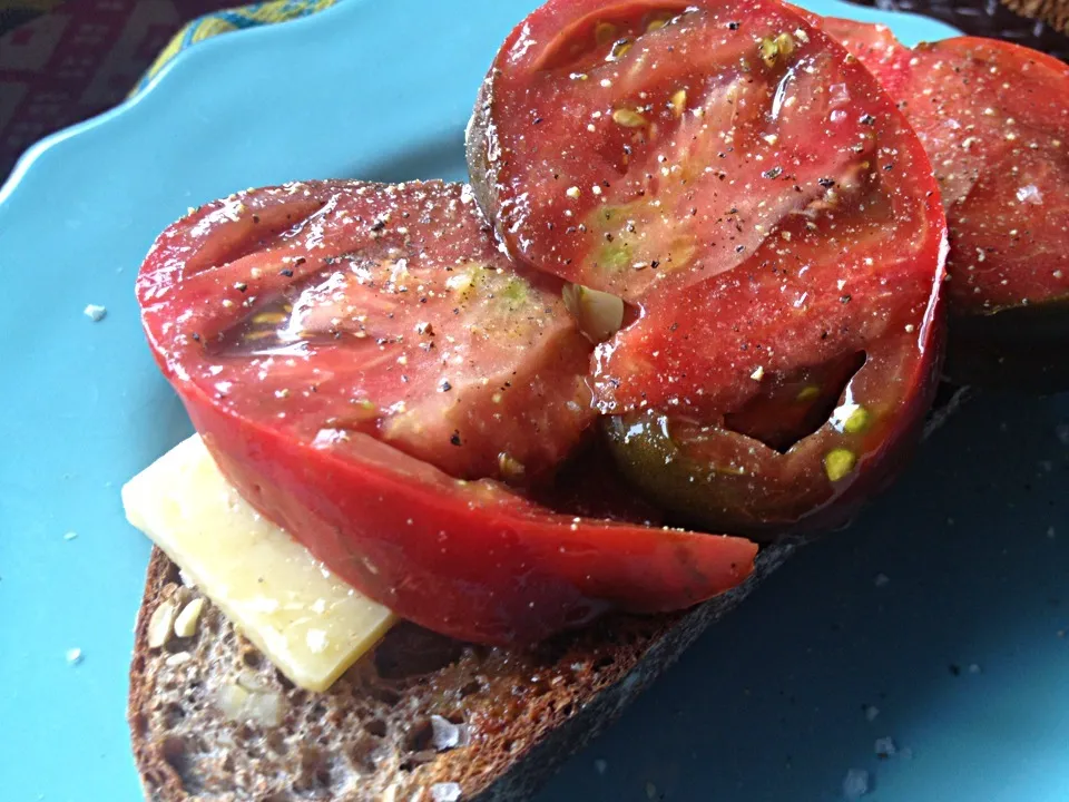 Snapdishの料理写真:Handcrafted artisan toast, Spring Hill sweet butter, cheddar, summer heirloom tomatoes sprinkled with sea salt.|monica szepesyさん