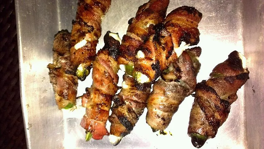 bacon wrapped jalapenos, with cream cheese and goat cheese stuffed in side. naturally I grilled them, since al things taste better kissed by an open flame.|Joshua Stephen Treadwayさん