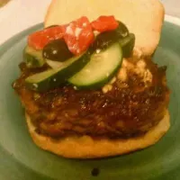 lambburger, seasoned with cumin, red salt, and a few others I won't mention, with feta cheese mixed in the meat, topped with kalamata olives, cucumber and tomat|Joshua Stephen Treadwayさん