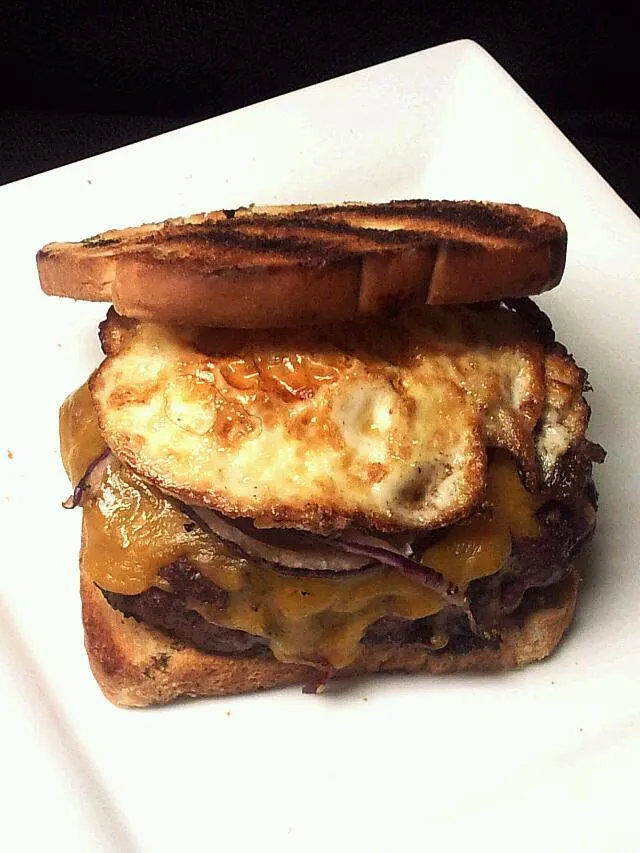 Snapdishの料理写真:prime rib burger with aged cheddar  grilled  red onion and fried egg on grilled white bread|Kevin Fatbelly Coleさん