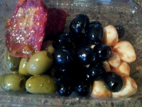 sun dried tomatoes, pickled paprika garlic,  back and green stuffed olives from the market.|hollyさん