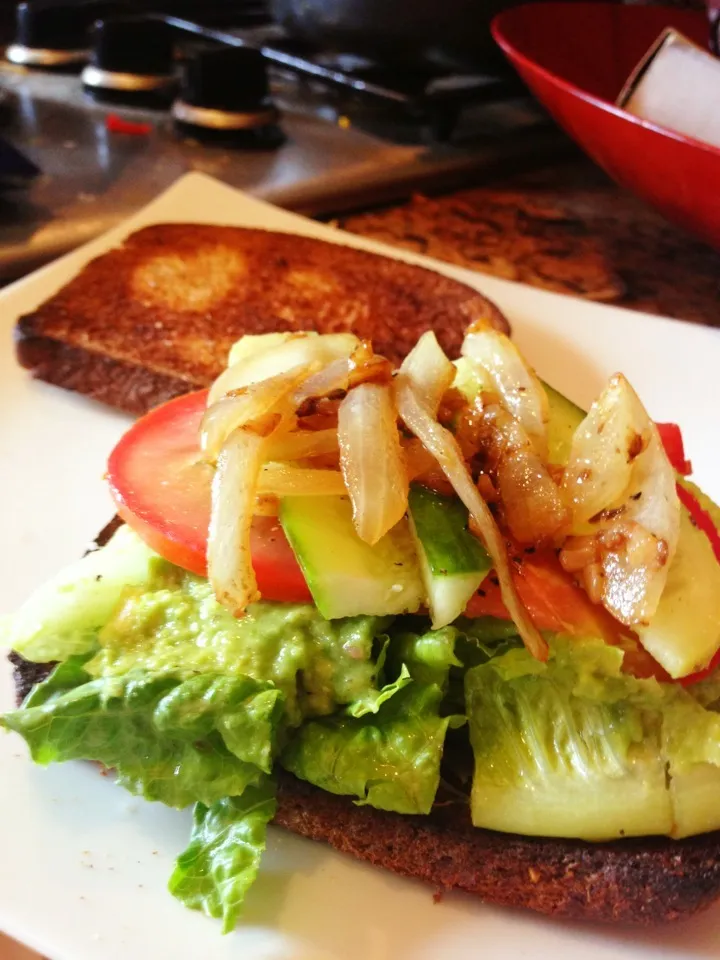 Snapdishの料理写真:Avocado sandwich with tomatoes, cucumbers, spinach, lettuce, and caramelized onions. Pepper and a squeeze of lemon to top it off|krista parkerさん