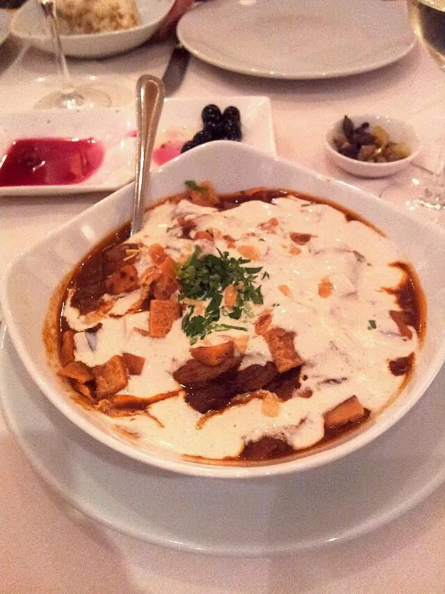 Lamb in a rich tomato sauce with fried bread, aubergines garlic herbs and white sauce.|hollyさん