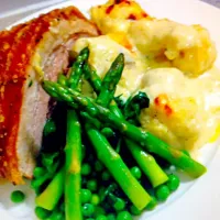 Crispy pork belly, cauliflower cheese, asparagus spinach and peas