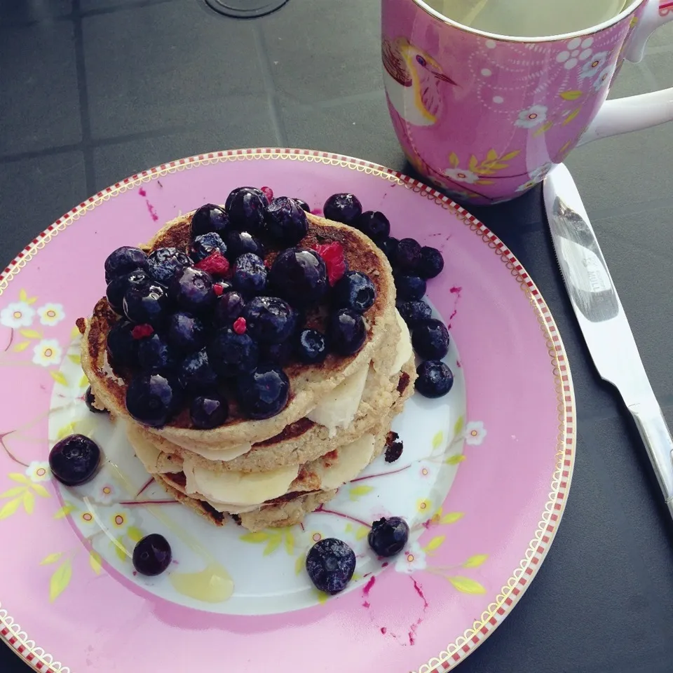 Snapdishの料理写真:Oat + coconut flour pancakes layered with almond butter and banana slices and topped with blue and raspberries|Rianneさん