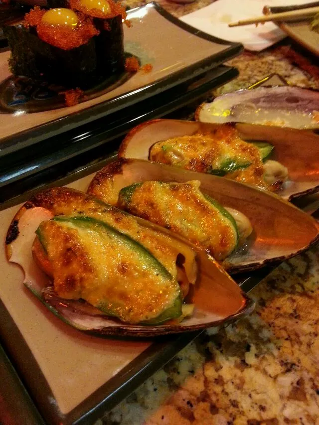 Snapdishの料理写真:baked mussels and a quail egg nestled in tobiko in the back ground I think its called izura|alisonさん