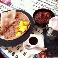 Snapdishの料理写真:Ethiopian cuisine: Doro Wott (Chicken stew) with Injera and Ethiopian coffee with herbs.|Sophia Wijnenさん