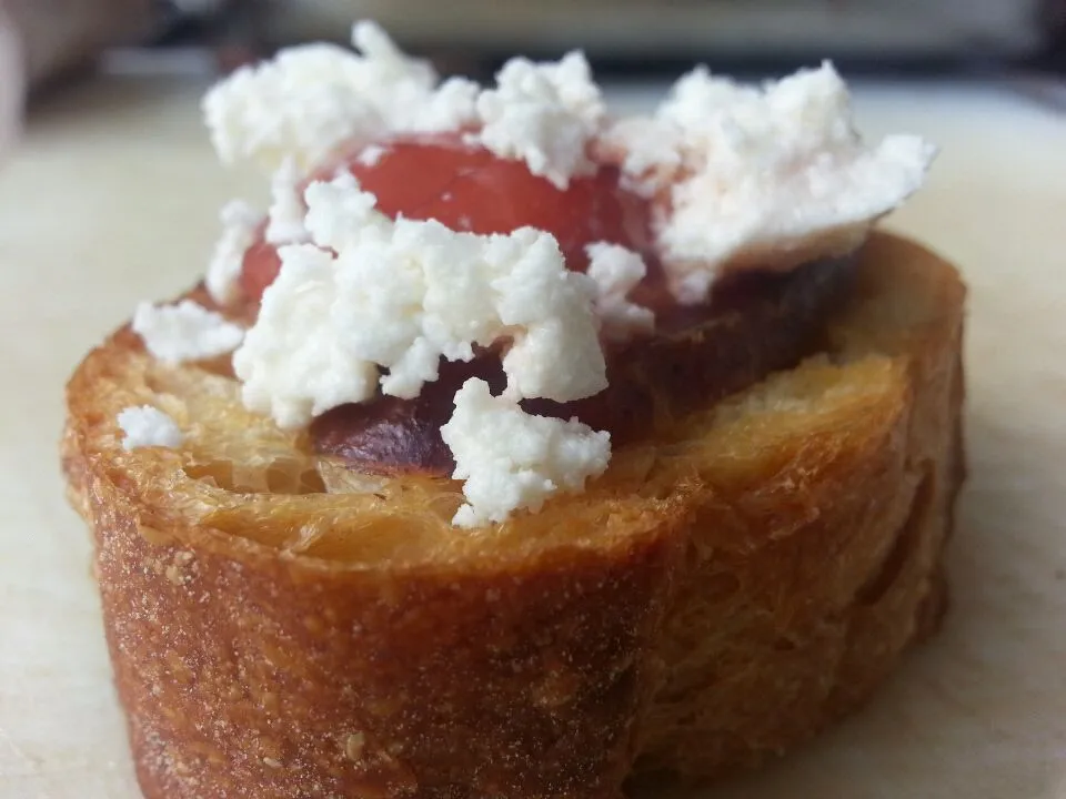 Mediterranean Bite of Sopresseta, Feta Cheese, and Tomato Explosion on a Garlic Crostini|Austin McKennaさん