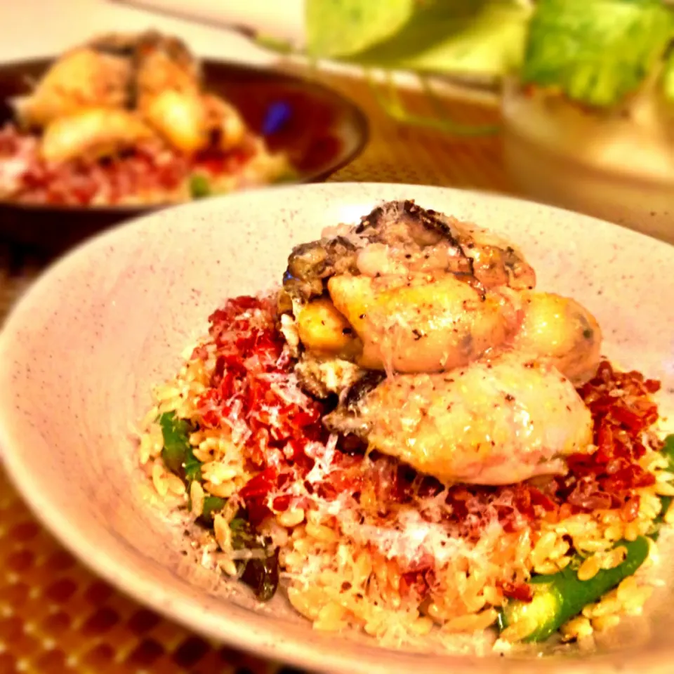 Two layered riso(rice shaped pasta) dish with asparagus spears and garlic sautéed oysters.|Kirk Awiamさん