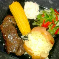 sirloin steak with cheesy jacket potatoe and corn|Michael Sandonさん