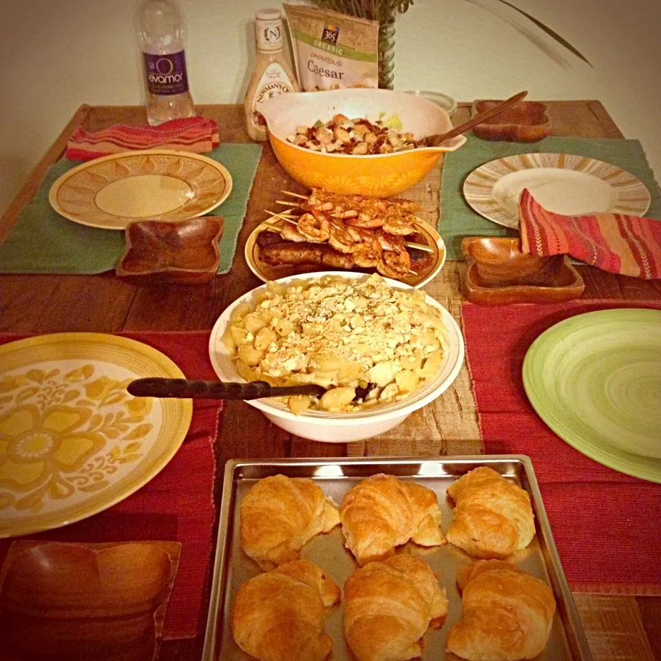 Snapdishの料理写真:Dinner party: we have croissants, baked Mac and cheese, sausage, bacon wrapped shrimp skewers, chili lime shrimp skewers, Caesar salad with handmade bacon bits,|Elise Templetさん