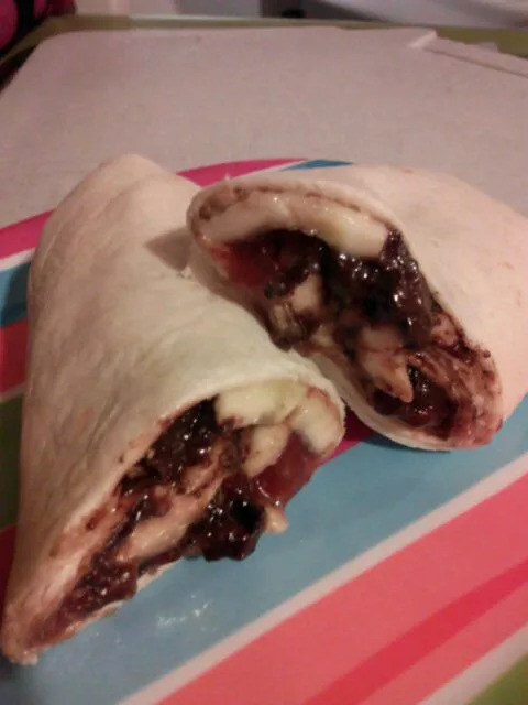 Snapdishの料理写真:Peanut butter, strawberry preserves, caramelized banana, and chocolate wrap.|Polly Gelfusoさん