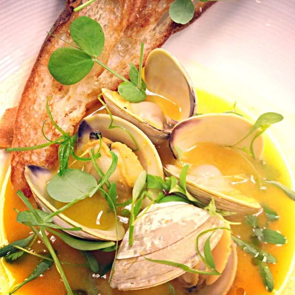 Snapdishの料理写真:Littleneck clams, white miso-saffron broth, toasted baguette|andrew franciscoさん