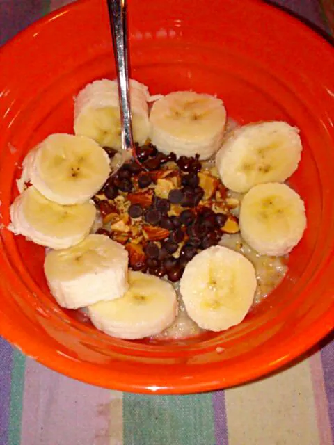 Cinnamon roll oatmeal with vegan chocolate chips, chopped almonds, and banana.|Polly Gelfusoさん