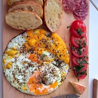 Farm fresh eggs over diced serrano, saucisse au sec, Roma tomato and cilantro, affedelice au chablis cheese, pan toasted belgian style  baguette|john rudolphさん