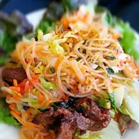 Snapdishの料理写真:Korean BBQ Flank Steak Lettuce Wrap topped with Sweet Potato Vermicelli sauteed with Sweet & Spicy Chili Garlic Green Papaya.|The JADE chefさん