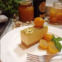 White chocolate cheesecake with kumquat compote and pistachio